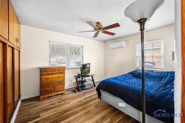 3171 Astor Ave, Toledo, OH 43614 - bedroom featuring a wall mounted air conditioner, light wood finished floors, and ceiling fan