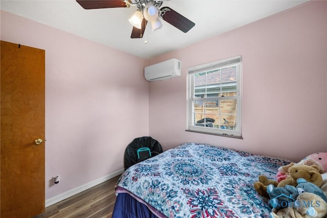 3171 Astor Ave, Toledo, OH 43614 - bedroom with a wall unit AC, wood finished floors, and ceiling fan