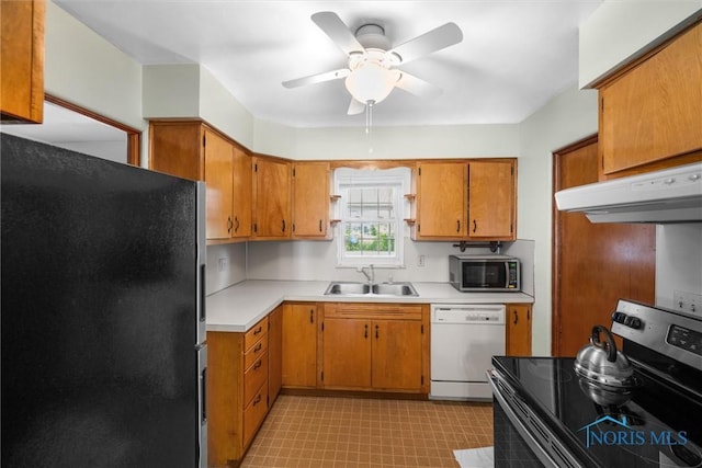 3171 Astor Ave, Toledo, OH 43614 - kitchen featuring appliances with stainless steel finishes, under cabinet range hood, light floors, a ceiling fan, and light countertops