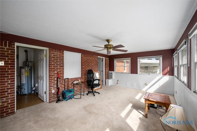 3171 Astor Ave, Toledo, OH 43614 - home office featuring water heater, carpet, ceiling fan, cooling unit, and brick wall