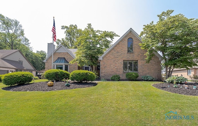 7325 Winsford Ln, Sylvania, OH 43560 - tudor house featuring brick siding and a front lawn