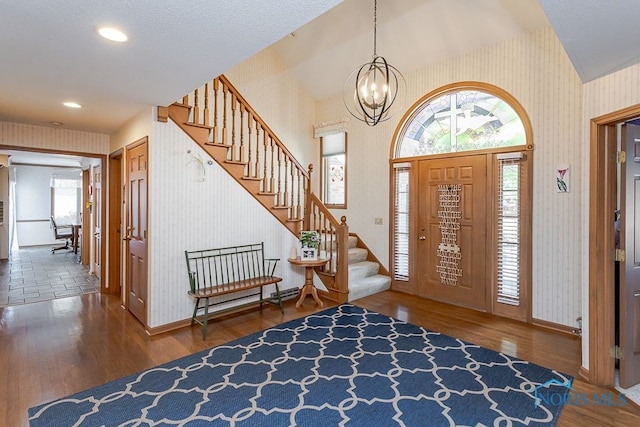 7325 Winsford Ln, Sylvania, OH 43560 - entryway featuring wallpapered walls, stairs, a chandelier, wood finished floors, and plenty of natural light