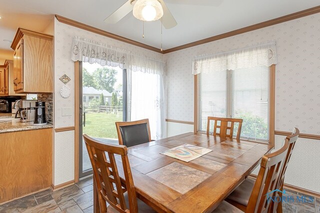 7325 Winsford Ln, Sylvania, OH 43560 - dining room with ceiling fan, ornamental molding, wallpapered walls, and light stone finish floors