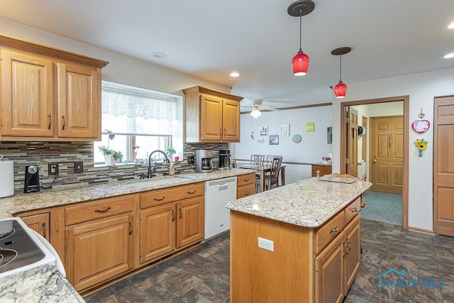 7325 Winsford Ln, Sylvania, OH 43560 - kitchen featuring white dishwasher, stone finish flooring, backsplash, ceiling fan, and pendant lighting