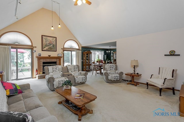 7325 Winsford Ln, Sylvania, OH 43560 - carpeted living area with high vaulted ceiling, a fireplace with raised hearth, and a ceiling fan