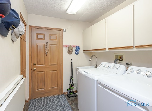 7325 Winsford Ln, Sylvania, OH 43560 - laundry room featuring washer and clothes dryer, cabinet space, and a textured ceiling