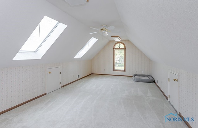 7325 Winsford Ln, Sylvania, OH 43560 - additional living space with a skylight, lofted ceiling, light colored carpet, and ceiling fan