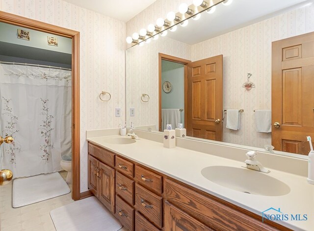 7325 Winsford Ln, Sylvania, OH 43560 - full bath with wallpapered walls and double vanity