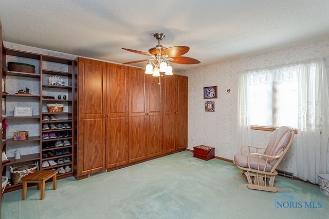 7325 Winsford Ln, Sylvania, OH 43560 - sitting room featuring light carpet, wallpapered walls, a ceiling fan, and a textured ceiling