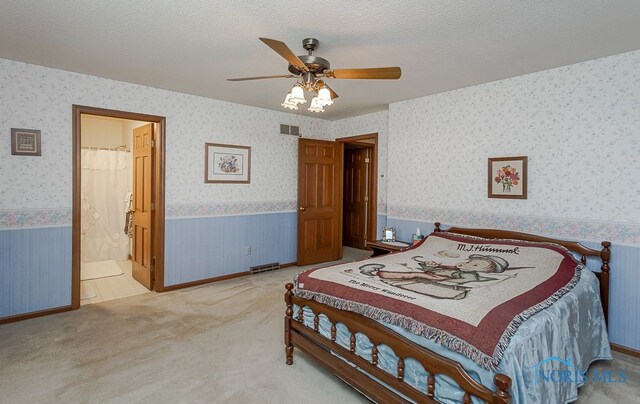 7325 Winsford Ln, Sylvania, OH 43560 - bedroom with wallpapered walls, wainscoting, light carpet, a ceiling fan, and ensuite bath