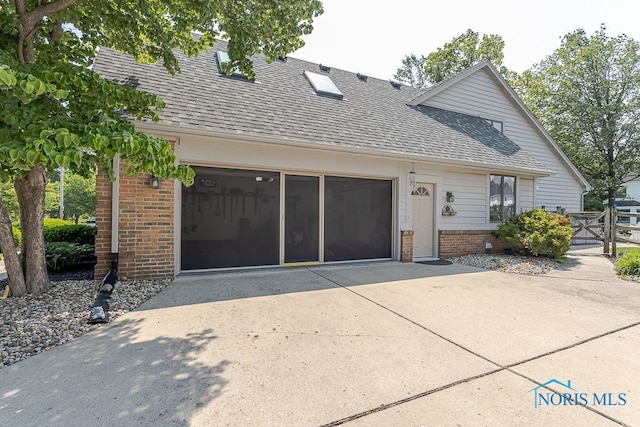 7325 Winsford Ln, Sylvania, OH 43560 - view of front of property featuring brick siding, a shingled roof, concrete driveway, and a gate
