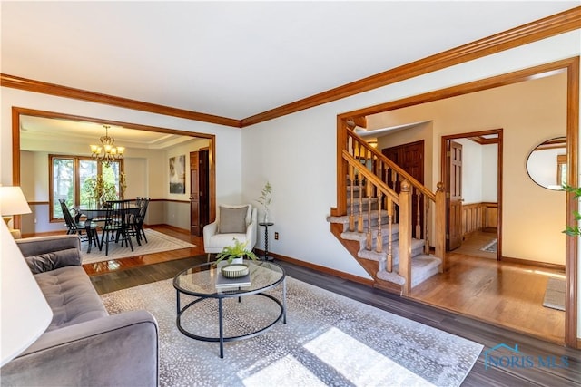2325 Saint Roberts Ln, Toledo, OH 43617 - living room with stairway, a chandelier, wood finished floors, and ornamental molding