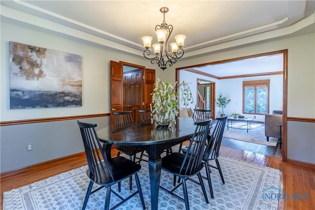 2325 Saint Roberts Ln, Toledo, OH 43617 - dining room featuring a chandelier and wood finished floors
