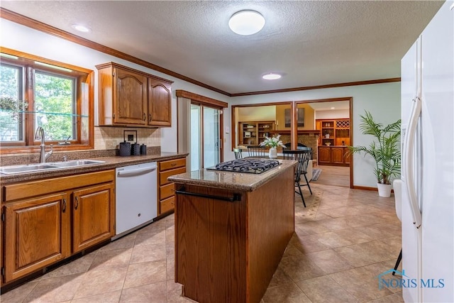 2325 Saint Roberts Ln, Toledo, OH 43617 - kitchen with white appliances, a center island, tasteful backsplash, a textured ceiling, and crown molding