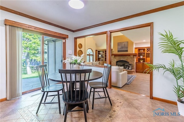 2325 Saint Roberts Ln, Toledo, OH 43617 - dining space featuring ornamental molding and a brick fireplace