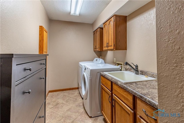 2325 Saint Roberts Ln, Toledo, OH 43617 - laundry area with independent washer and dryer, cabinet space, a textured wall, a textured ceiling, and light tile patterned floors