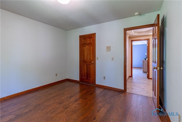 2325 Saint Roberts Ln, Toledo, OH 43617 - spare room featuring dark wood-style floors and a smoke detector