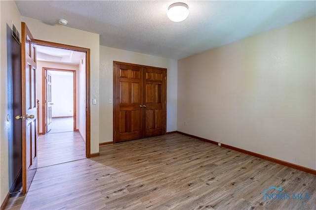 2325 Saint Roberts Ln, Toledo, OH 43617 - unfurnished bedroom featuring light wood-type flooring and a closet
