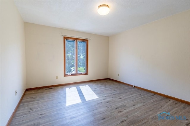2325 Saint Roberts Ln, Toledo, OH 43617 - spare room featuring wood finished floors and baseboards