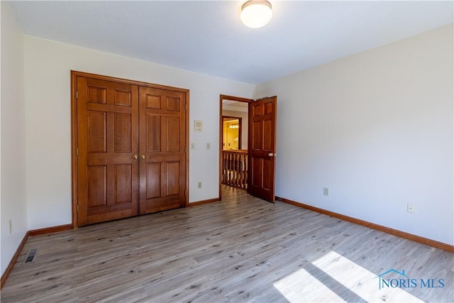 2325 Saint Roberts Ln, Toledo, OH 43617 - unfurnished bedroom featuring light wood-style flooring and a closet