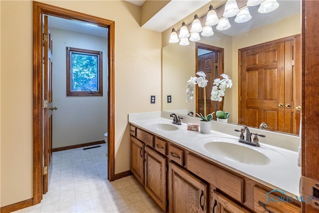 2325 Saint Roberts Ln, Toledo, OH 43617 - bathroom featuring double vanity and toilet