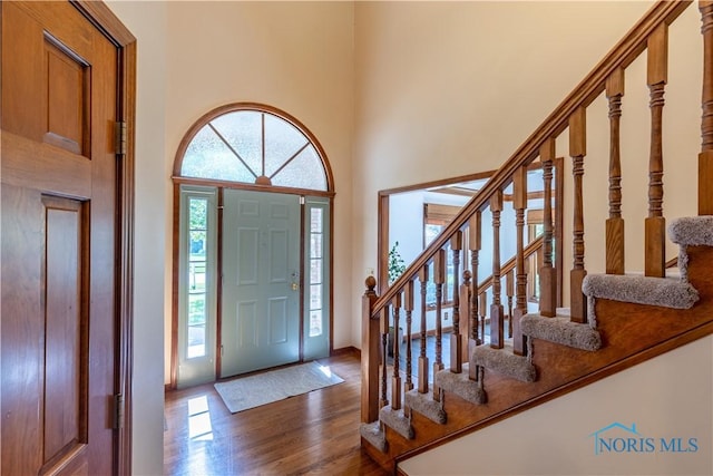 2325 Saint Roberts Ln, Toledo, OH 43617 - foyer entrance featuring dark wood-type flooring, stairs, and a high ceiling
