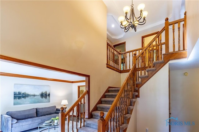 2325 Saint Roberts Ln, Toledo, OH 43617 - stairway with a chandelier, crown molding, and a towering ceiling