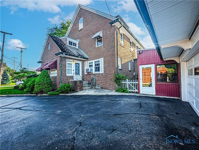 120 Elm St, Fostoria, OH 44830 - view of property exterior featuring brick siding