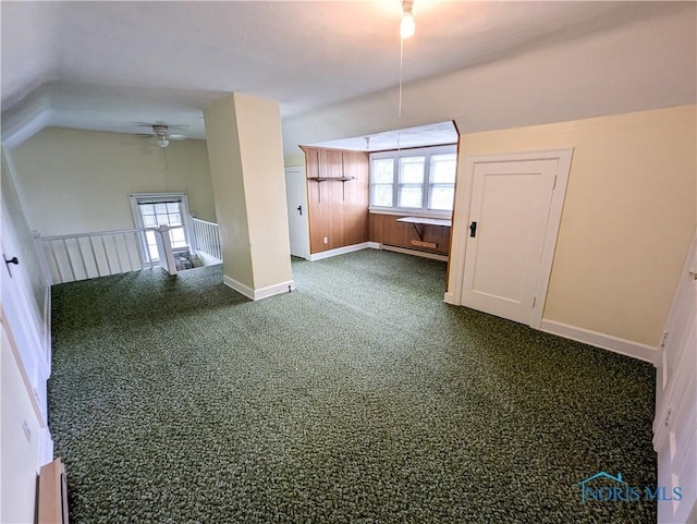 120 Elm St, Fostoria, OH 44830 - unfurnished room with vaulted ceiling, a baseboard heating unit, dark colored carpet, a ceiling fan, and baseboard heating