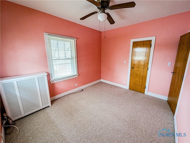 120 Elm St, Fostoria, OH 44830 - carpeted empty room featuring radiator and a ceiling fan