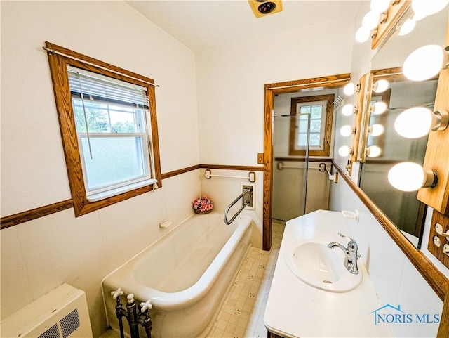 120 Elm St, Fostoria, OH 44830 - full bath featuring a garden tub, plenty of natural light, and vanity