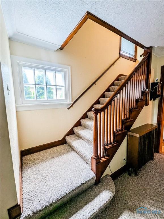 120 Elm St, Fostoria, OH 44830 - stairs featuring a textured ceiling and carpet floors