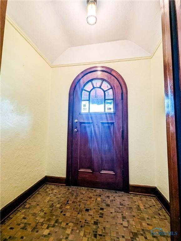 120 Elm St, Fostoria, OH 44830 - entrance foyer with vaulted ceiling, arched walkways, and a textured wall