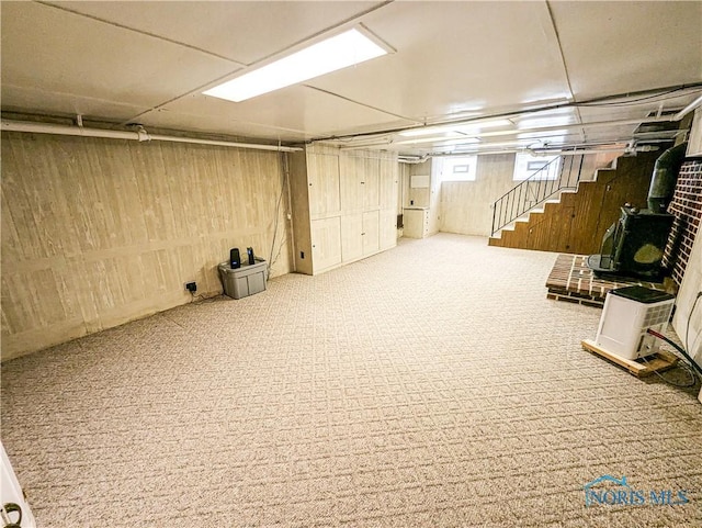 120 Elm St, Fostoria, OH 44830 - basement featuring carpet floors, stairs, and a wood stove