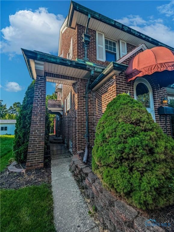 120 Elm St, Fostoria, OH 44830 - view of front of property featuring brick siding