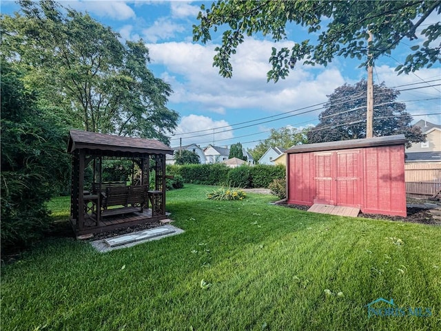 120 Elm St, Fostoria, OH 44830 - view of grassy yard featuring a storage unit and a gazebo