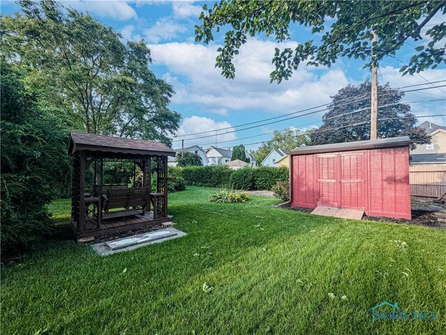 120 Elm St, Fostoria, OH 44830 - view of green lawn featuring a storage shed and a gazebo