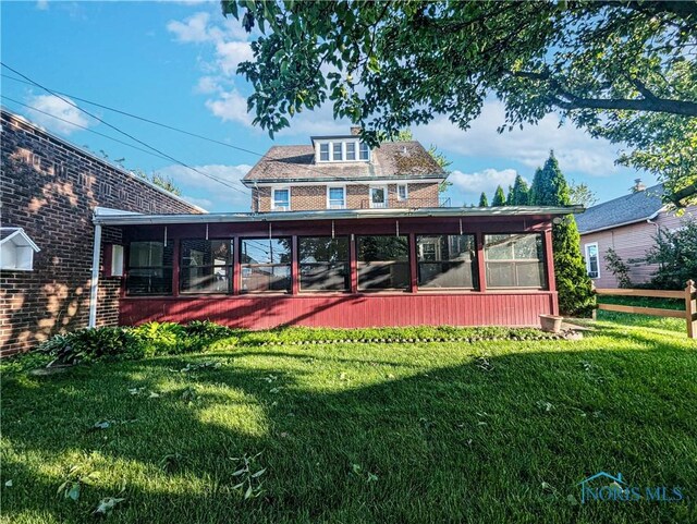 120 Elm St, Fostoria, OH 44830 - back of property featuring a sunroom and a lawn