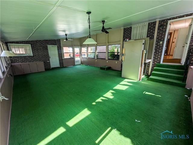 120 Elm St, Fostoria, OH 44830 - interior space featuring brick wall and carpet