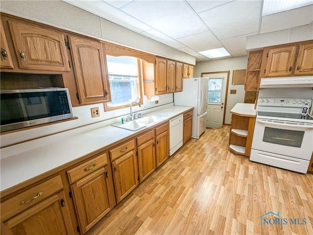 120 Elm St, Fostoria, OH 44830 - kitchen featuring white appliances, open shelves, under cabinet range hood, light wood-style floors, and brown cabinets