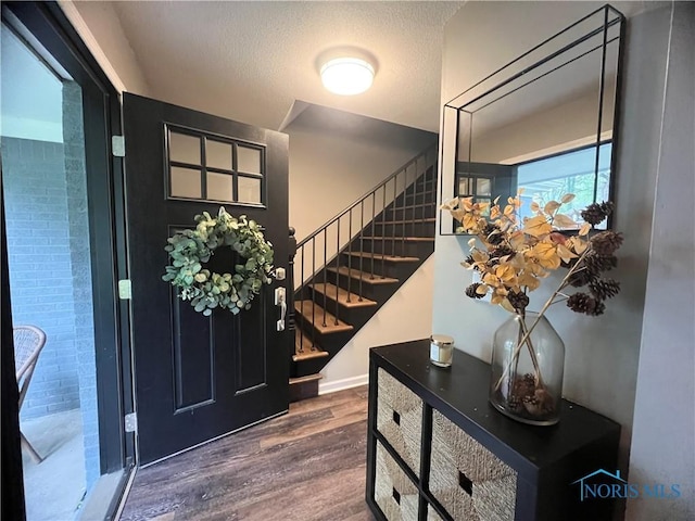 3822 Sylvan Wood Dr, Sylvania, OH 43560 - foyer featuring wood finished floors, stairs, and a textured ceiling
