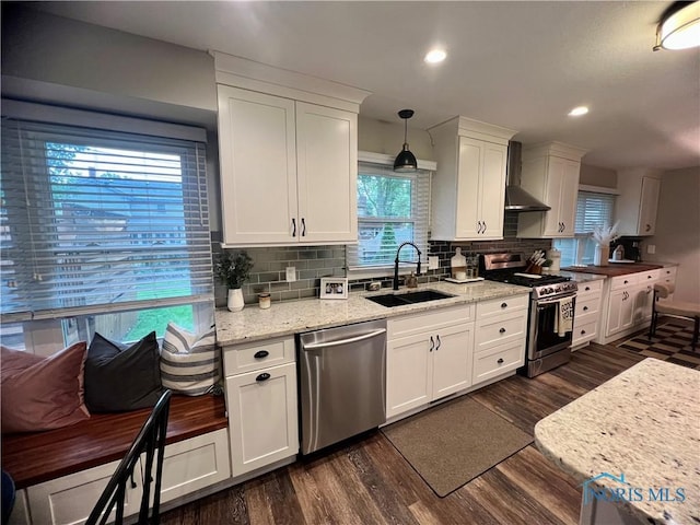3822 Sylvan Wood Dr, Sylvania, OH 43560 - kitchen with stainless steel appliances, wall chimney exhaust hood, tasteful backsplash, white cabinetry, and recessed lighting