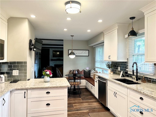 3822 Sylvan Wood Dr, Sylvania, OH 43560 - kitchen with dishwasher, white cabinets, dark wood finished floors, tasteful backsplash, and recessed lighting