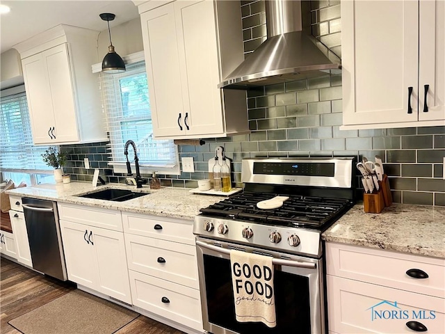 3822 Sylvan Wood Dr, Sylvania, OH 43560 - kitchen featuring stainless steel appliances, wall chimney range hood, white cabinetry, backsplash, and light stone countertops