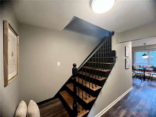 3822 Sylvan Wood Dr, Sylvania, OH 43560 - stairs with wood finished floors and a textured ceiling