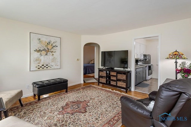 921 7th St, Maumee, OH 43537 - living room featuring arched walkways and wood finished floors