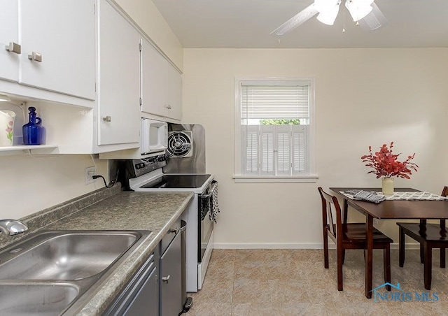 921 7th St, Maumee, OH 43537 - kitchen featuring white appliances, white cabinetry, ceiling fan, and dark countertops