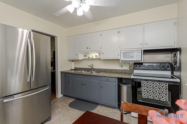 921 7th St, Maumee, OH 43537 - kitchen with freestanding refrigerator, black / electric stove, white microwave, dark countertops, and a ceiling fan