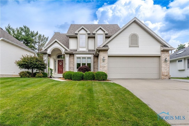 6666 Brick Yard Ct, Maumee, OH 43537 - view of front facade with a shingled roof, concrete driveway, a front yard, brick siding, and a garage