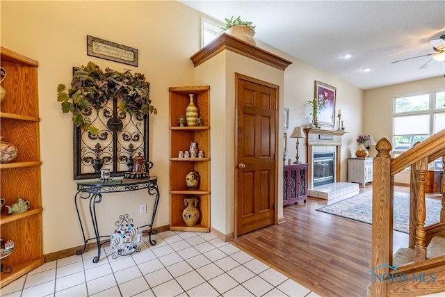 6666 Brick Yard Ct, Maumee, OH 43537 - foyer featuring a ceiling fan, a tiled fireplace, and stairway